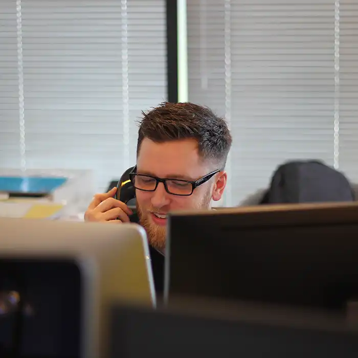 A person using a desk phone